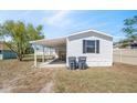 Exterior view of home with white siding and a covered carport at 4957 Old Lucerne Park Rd, Winter Haven, FL 33881