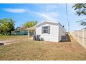 Exterior view of home with white siding and a covered carport at 4957 Old Lucerne Park Rd, Winter Haven, FL 33881