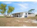 Exterior view of home with white siding and a covered carport at 4957 Old Lucerne Park Rd, Winter Haven, FL 33881