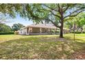 Spacious front yard frames this lovely home with a stone column porch, enhancing its inviting curb appeal at 5020 Broadmore Dr, Auburndale, FL 33823
