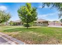 Beautifully landscaped lawn showcases this single-story house with mature trees and green shrubbery at 5020 Broadmore Dr, Auburndale, FL 33823