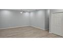 Bright room boasts new laminate flooring, fresh paint, modern ceiling fan, and closet storage at 615 Avenue S Ne, Winter Haven, FL 33881