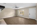 Bright living room with wood floors, neutral walls, a ceiling fan and large window at 6430 Russo Rd, Bartow, FL 33830