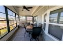 A cozy screened porch with comfortable seating, ceiling fan and nice flooring at 6450 Hollyberry Ne Ln, Winter Haven, FL 33881