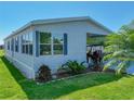 Single-story home with manicured lawn, partial carport, and meticulous landscaping at 6603 Scenic Point Se Dr, Winter Haven, FL 33884