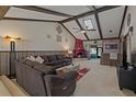 Spacious living room with wood beam vaulted ceilings, and cozy fireplace, and stylish decor at 6754 Winterset Gardens Rd, Winter Haven, FL 33884