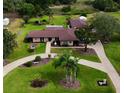 Sprawling property with lush landscaping, long driveway, and charming ranch-style home in a serene, park-like setting at 8947 Oakwood Dr, Lake Wales, FL 33898