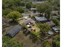 Expansive aerial view showcases the property's layout, surrounding greenery, and highlighting the backyard pool at 903 S Lakeview Ave, Bartow, FL 33830