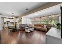 Inviting open-concept living room and kitchen with wood floors, ample natural light, and seamless flow for entertaining at 903 S Lakeview Ave, Bartow, FL 33830