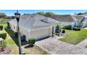An overhead view of a home showing the driveway and manicured front yard at 916 Balmoral Dr, Davenport, FL 33896