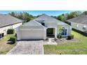 Lovely home with a two-car garage, complemented by beautiful landscaping and a colorful brick driveway at 916 Balmoral Dr, Davenport, FL 33896