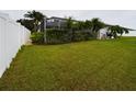 Expansive backyard featuring lush green grass and a privacy fence, perfect for outdoor activities and relaxation at 7726 Ashford Dr, Lakeland, FL 33810