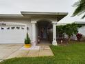 Inviting home entrance with a decorative front door, manicured landscaping, and a bright, welcoming atmosphere at 7726 Ashford Dr, Lakeland, FL 33810
