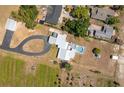 Aerial view of the home showing a pool, circular driveway, and landscaping at 100 Masterpiece Rd, Lake Wales, FL 33898