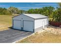 Two-car garage with a gray metal roof and siding, perfect for storage or hobbies at 100 Masterpiece Rd, Lake Wales, FL 33898