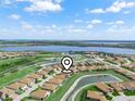 Stunning aerial view of a beautiful community with lush green spaces and sparkling lakes at 1057 Sawgrass Dr, Winter Haven, FL 33884