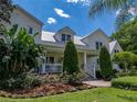 Charming home exterior boasting lush greenery, a well-manicured lawn and a covered porch at 125 E Graham Park Dr, Haines City, FL 33844