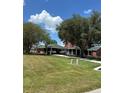 Beautiful home featuring a covered carport, spacious lawn, and mature trees, offering ample parking at 1403 Hidden Creek Ln, Winter Haven, FL 33880