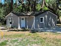 Cozy gray home with a white front door, newly renovated at 180 Old Connersville Rd, Bartow, FL 33830