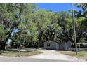 Charming renovated home with a gray exterior and a circular driveway at 180 Old Connersville Rd, Bartow, FL 33830