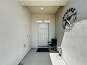 Inviting front porch with textured walls, white door, and decorative star at 229 Elm Ct, Kissimmee, FL 34759