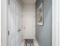 Hallway view, with a bedroom door and a closet door at 229 Elm Ct, Kissimmee, FL 34759