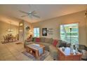 Inviting living room with tile floors, a ceiling fan, and comfortable seating for relaxing or entertaining at 2654 Rutledge Ct, Winter Haven, FL 33884