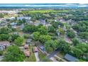 Expansive aerial view showcases the community with lush trees and surrounding lakes at 320 S Elm Rd, Lakeland, FL 33801