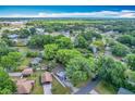Aerial view showing the property nestled within a green neighborhood, surrounded by trees and residences at 320 S Elm Rd, Lakeland, FL 33801