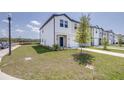 New construction townhome with green lawn and landscaping at 3265 Vesara Dr, Davenport, FL 33837