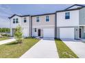 Attractive townhome showcases diverse facades and driveway leading to garage at 3269 Vesara, Davenport, FL 33837