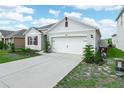 A well-maintained home featuring a spacious driveway and a two-car garage at 3862 Whitney Way, Haines City, FL 33844
