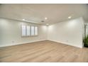 Spacious living room with new floors, a window with shutters and recessed lighting at 409 Greenfield Rd, Winter Haven, FL 33884