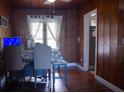 Inviting dining area showcases natural wood paneling and hardwood floors, creating a warm and cozy atmosphere at 420 N 5Th St, Lake Wales, FL 33853