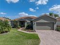 Charming single-story home with a well-maintained lawn, brick driveway, and inviting curb appeal at 4279 Ashton Club Dr, Lake Wales, FL 33859