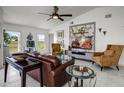 Bright living room with a ceiling fan, marble tile floors, modern decor, and bright windows at 530 Eastlake Dr, Haines City, FL 33844