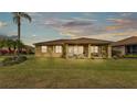 Spacious backyard featuring a screened-in porch and lush lawn perfect for outdoor living and entertaining at 5341 Hogan Ln, Winter Haven, FL 33884