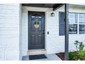 Close-up of the home's front door featuring a welcoming wreath and stylish exterior at 612 Ralph St, Auburndale, FL 33823