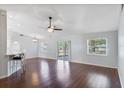 Bright living room featuring hardwood floors, a ceiling fan, and sliding glass doors to the outdoor space at 6560 Horizon Point Dr, Lakeland, FL 33813