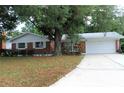 Charming one-story brick home featuring an attached garage and a well-manicured front lawn at 670 Avenue N Se, Winter Haven, FL 33880