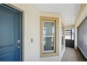 Inviting entryway with a blue front door, security features, and a covered porch area at 730 Colville Pl, Kissimmee, FL 34759