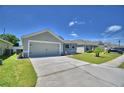 Beautiful single-story home featuring a spacious driveway and manicured lawn at 8243 Campbell Crossing Cir, Lakeland, FL 33810