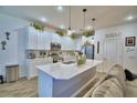 Bright kitchen featuring a center island, modern appliances, pendant lighting, and ample cabinet space at 825 Grazie Loop, Davenport, FL 33837