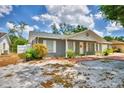 Well-maintained single-story home with a gray brick exterior and manicured landscaping at 842 Cinnamon Dr, Winter Haven, FL 33880