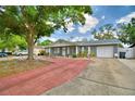 Lovely single-story home featuring an attached garage and a red brick driveway at 842 Cinnamon Dr, Winter Haven, FL 33880