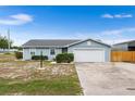 This charming single-story home features an attached garage, manicured landscaping, and a welcoming atmosphere at 100 Ellen Ct, Winter Haven, FL 33884