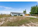 Quaint single-story home with a spacious yard, attached garage, and wooden fence, providing comfort and privacy at 100 Ellen Ct, Winter Haven, FL 33884