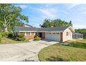 Single-story brick home with a two-car garage and well-maintained landscaping at 102 Lake Ring Dr, Winter Haven, FL 33884