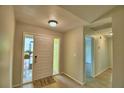 Open foyer featuring a front door with sidelights and stylish wood-look flooring at 103 Lake Thomas Dr, Winter Haven, FL 33880