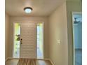 Bright entryway with light walls, a front door with sidelights and a hallway entrance at 103 Lake Thomas Dr, Winter Haven, FL 33880